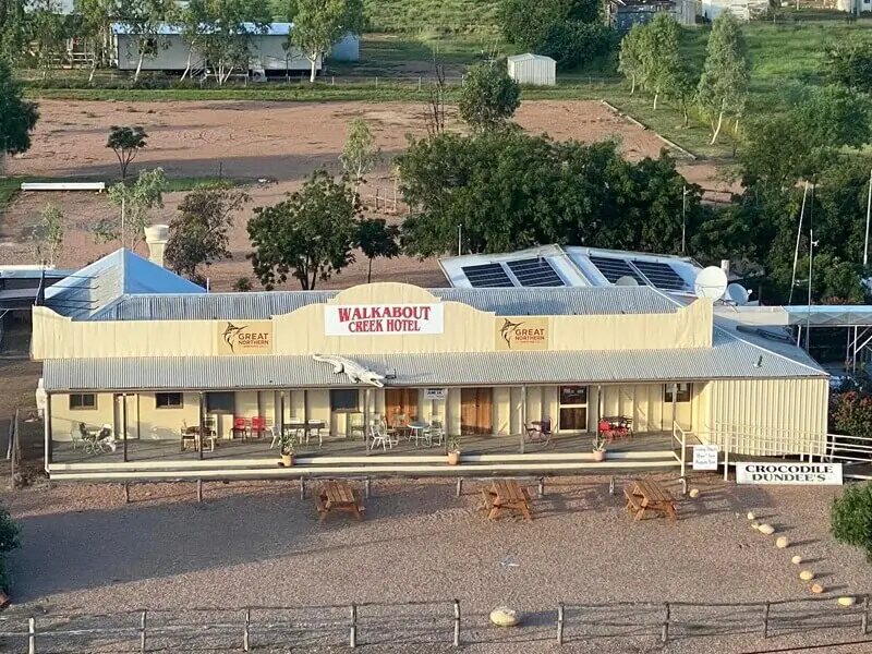 Three wooden tables outside Crocodile Dundee's Walkabout Creek Hotel, McKinlay QLD