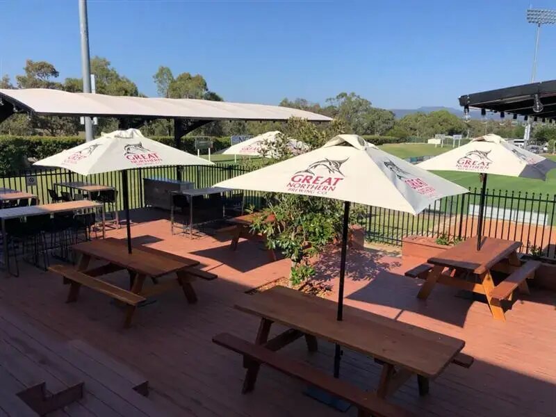 Commercial wooden picnic tables on a hardwood deck