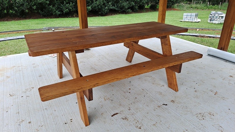 Kiln dried hardwood table under an awning
