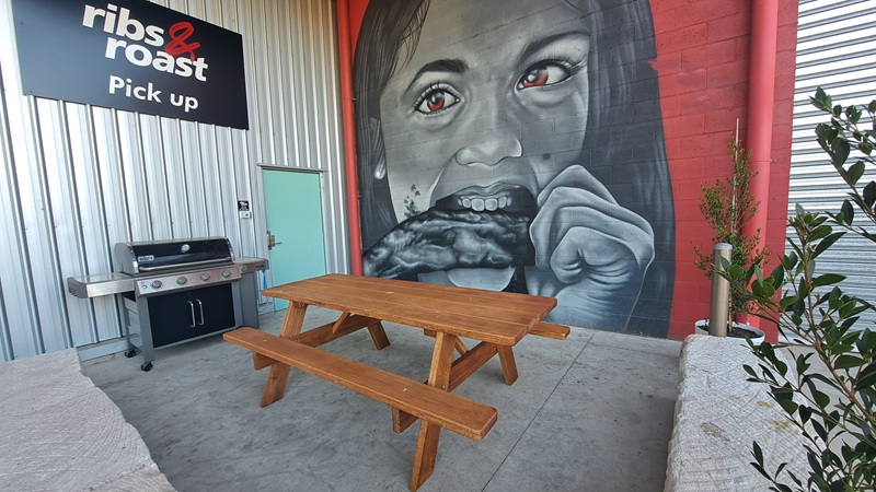 A timber picnic table at Ribs N Roast Penrith