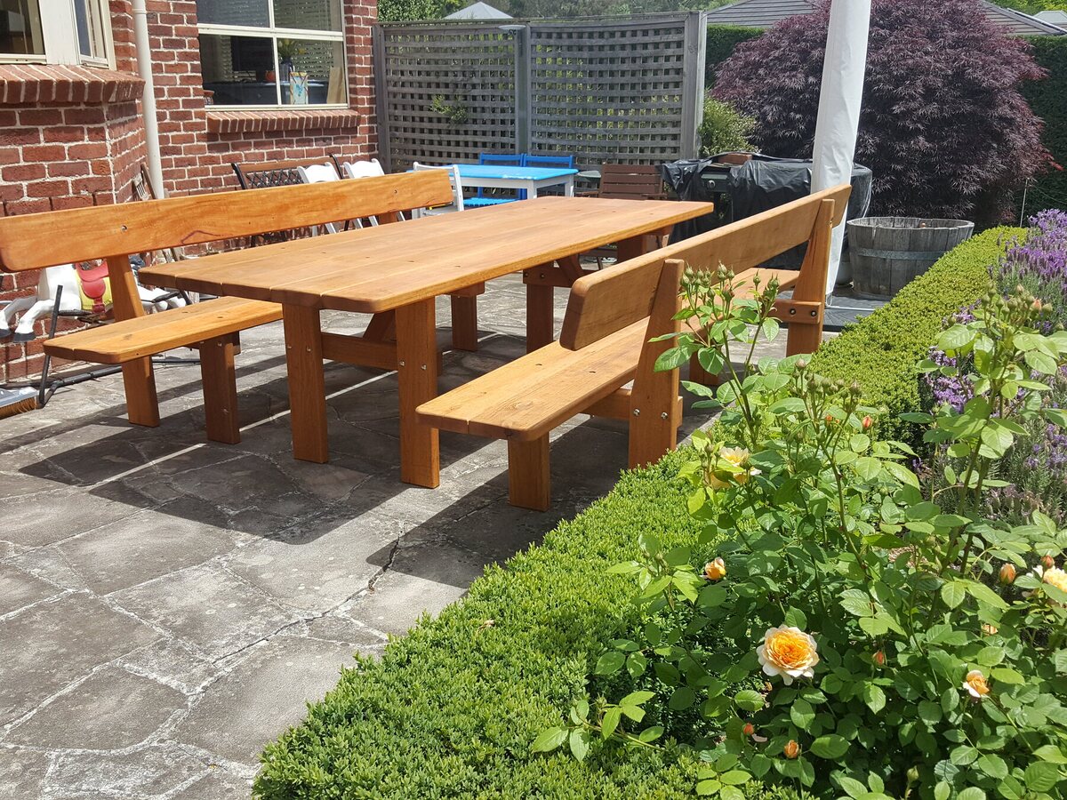 Long hardwood garden table with separate backrest benches