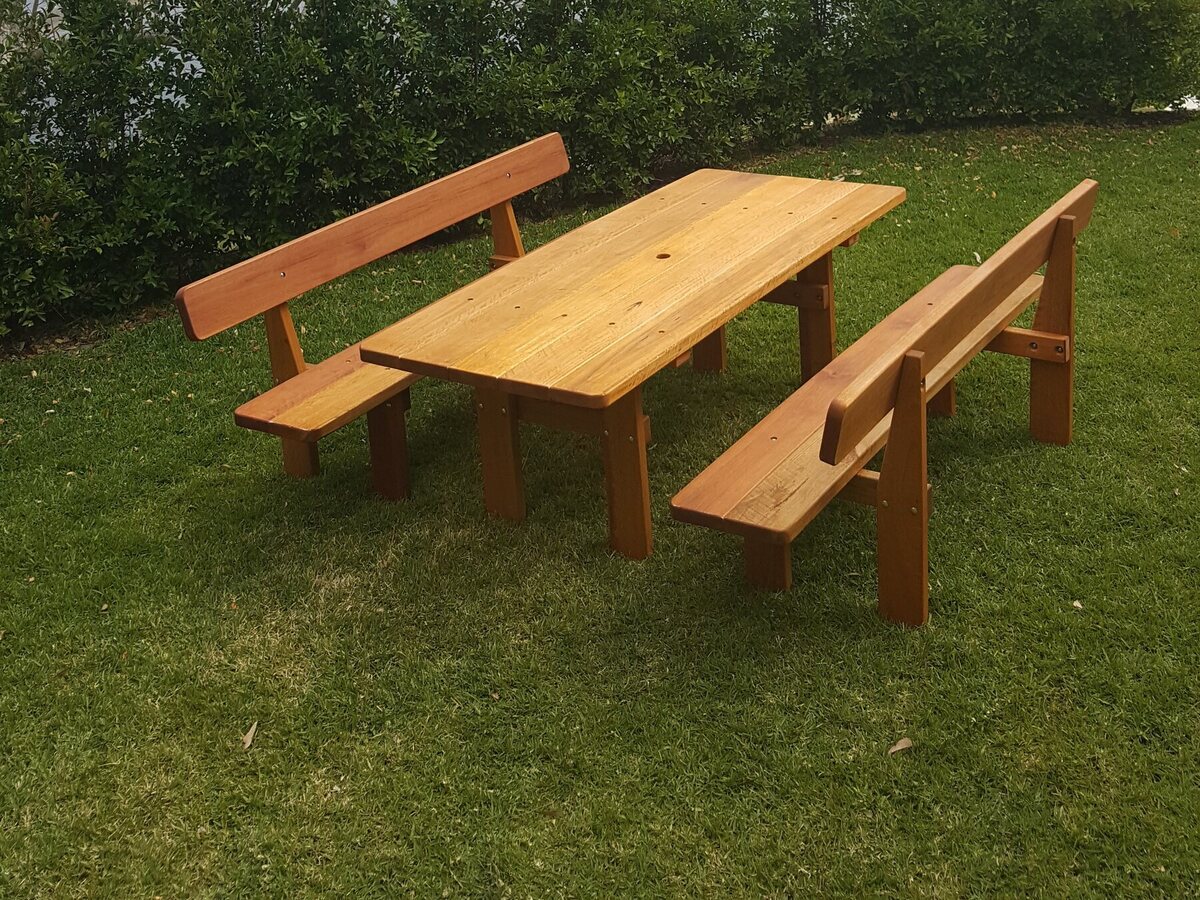 Three-piece picnic table with backrests on a wooden deck