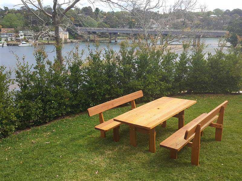 Three piece picnic table on a wooden deck